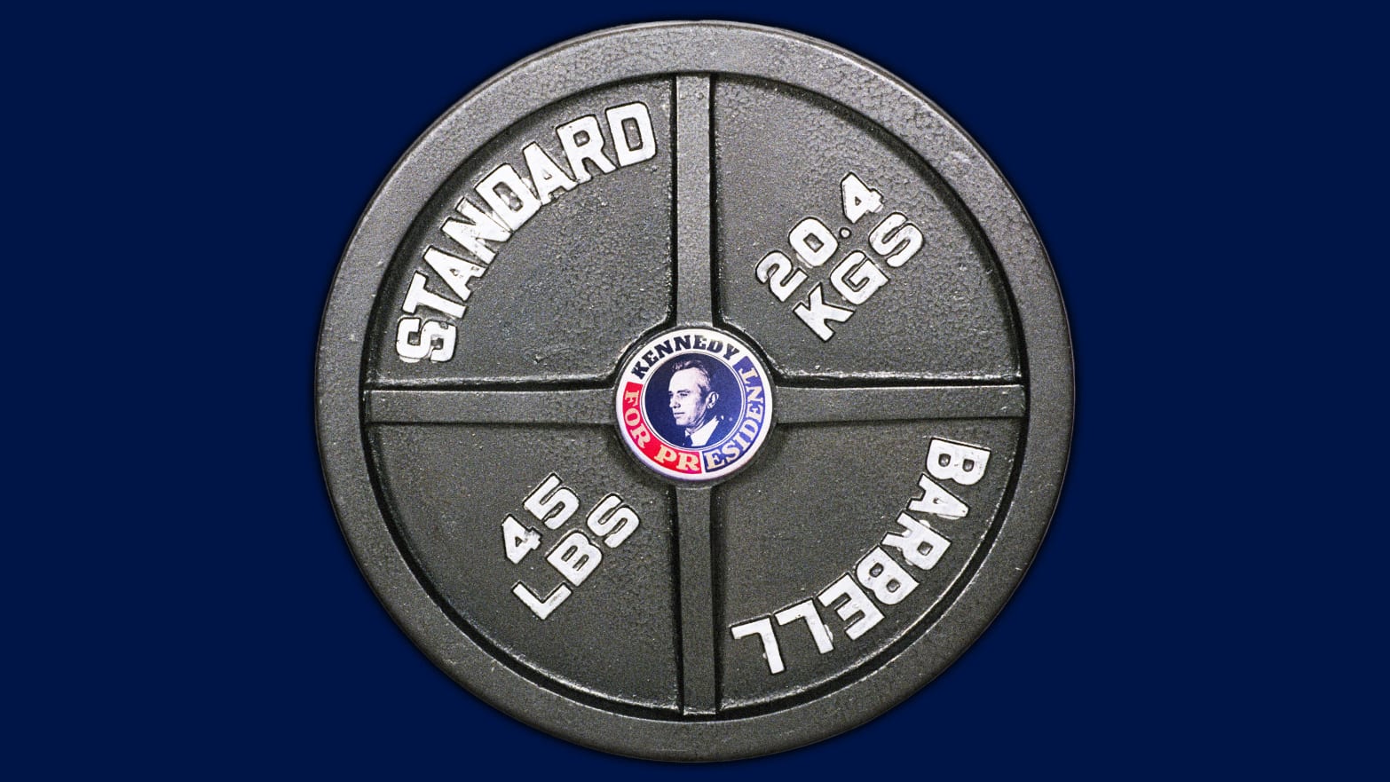 A weightlifting barbell plate with a Robert F. Kennedy Jr. campaign pin