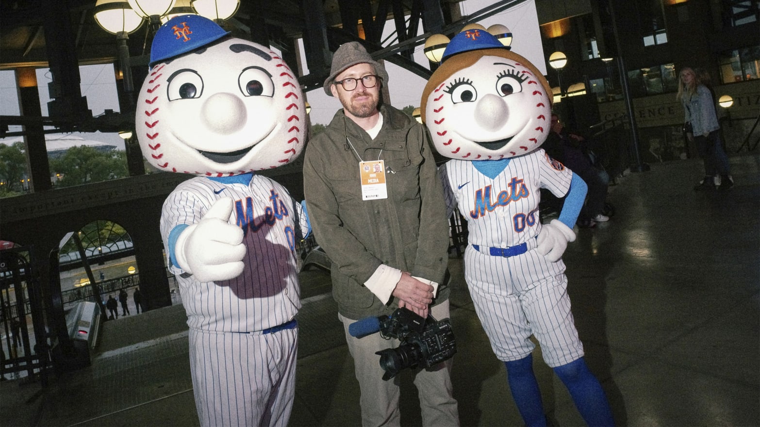 John Wilson poses with Mr and Mrs Met at Mets Stadium.