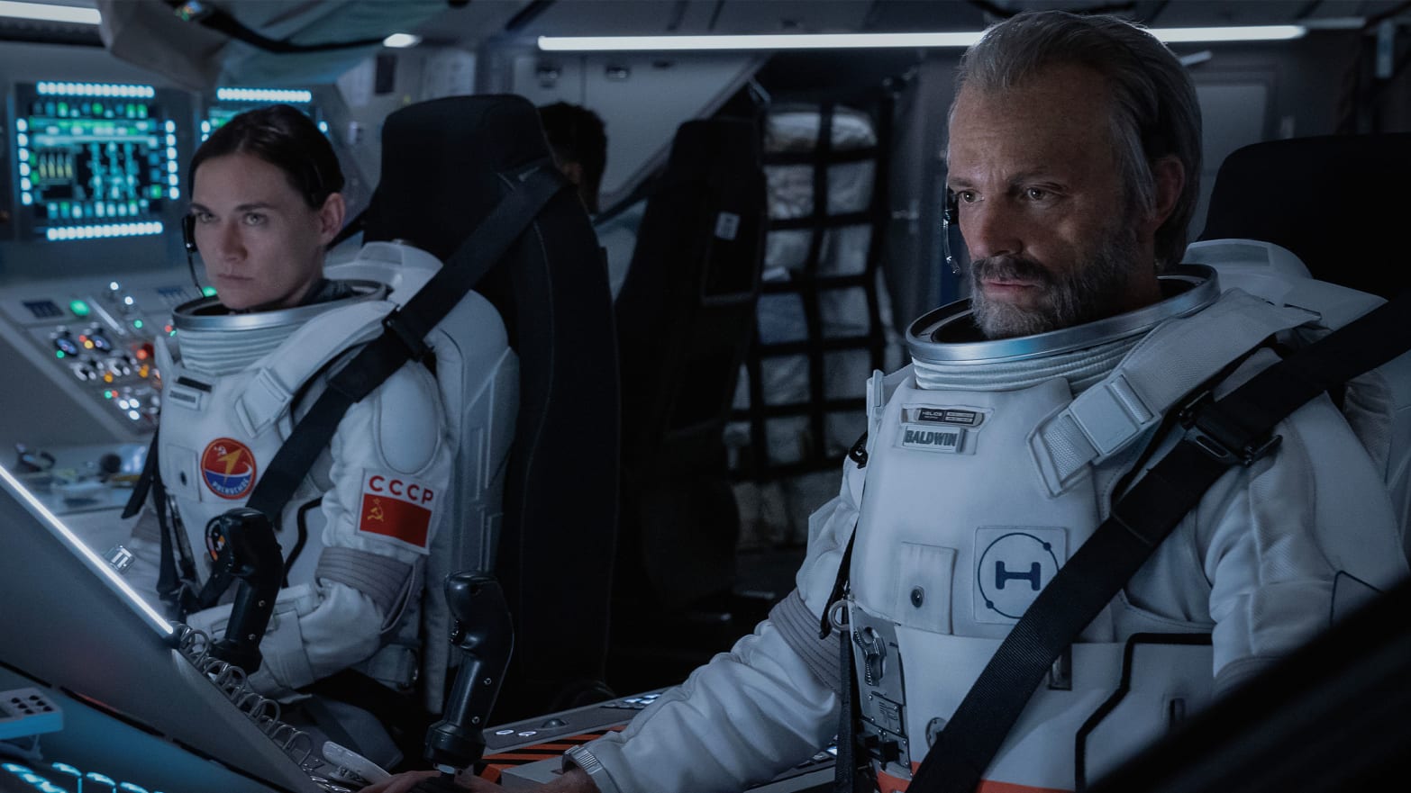 A still of Masha Mashkova and Joel Kinnaman in a space ship in 'For All of Mankind'