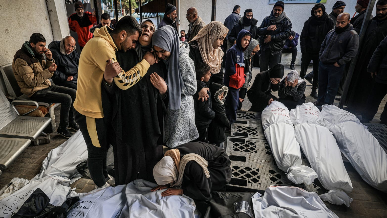 Palestinians mourn after identifying corpses of relatives killed in overnight Israeli bombardment.