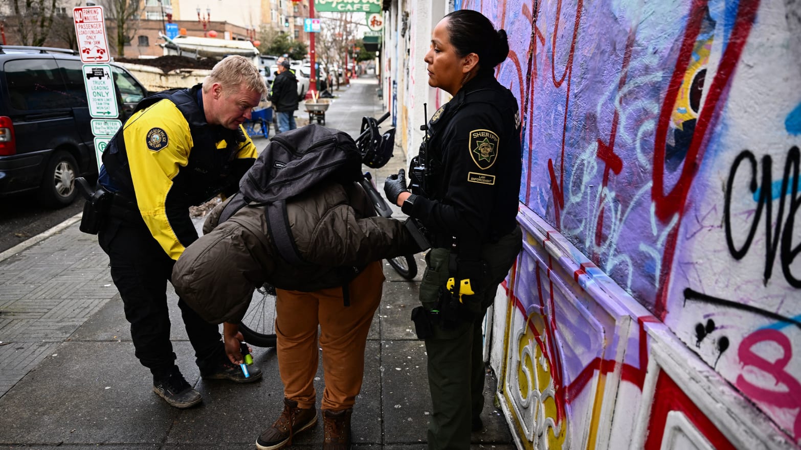 Two officers arrest a man in downtown Portland. 