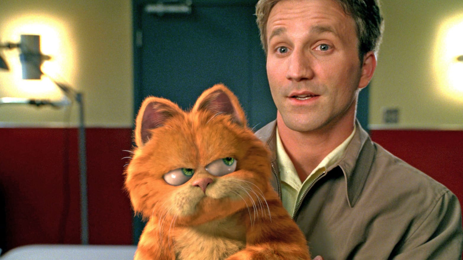 Breckin Meyer holds Garfield in a still from 'Garfield: The Movie”