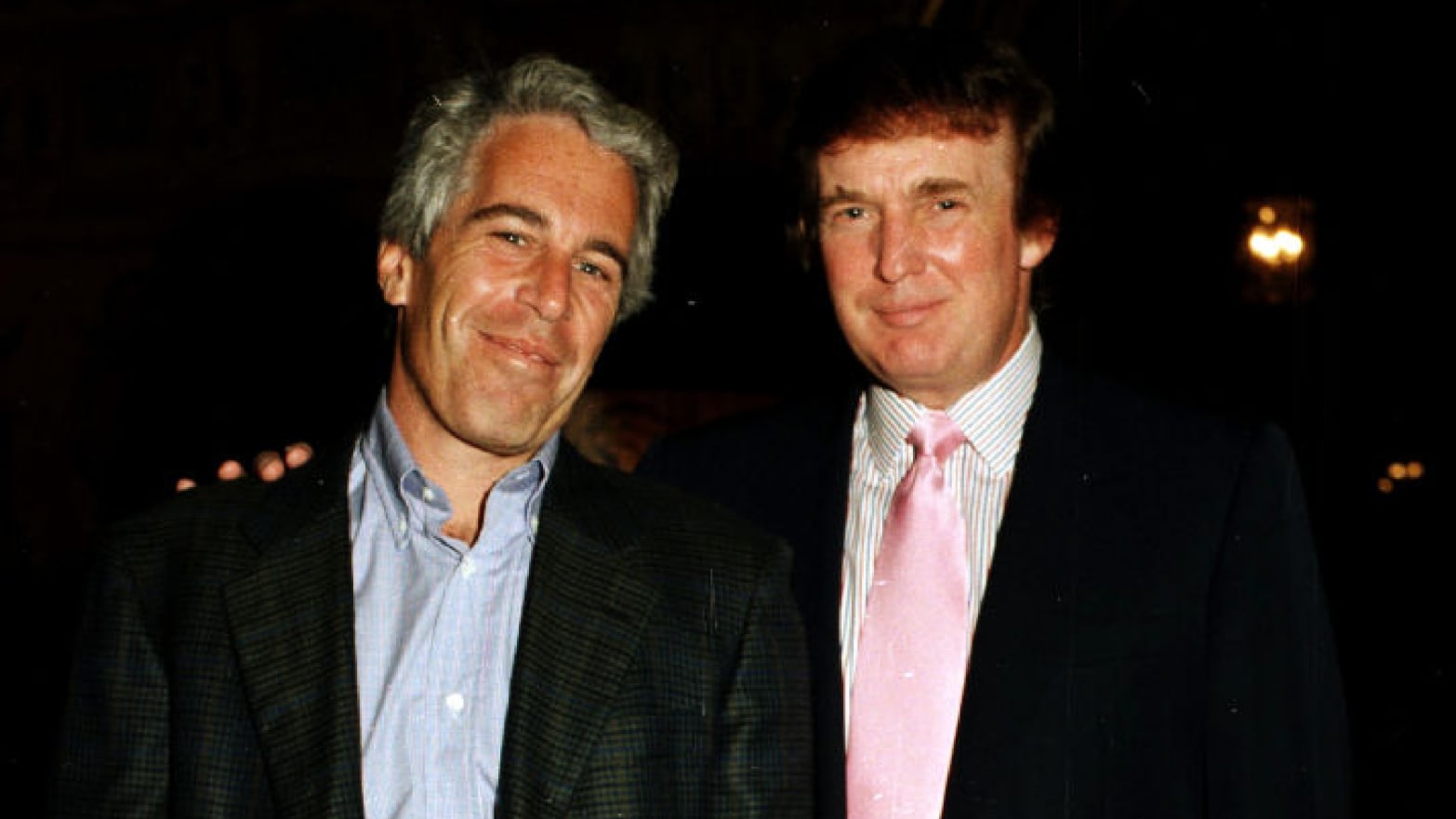 Donald Trump poses for a photo with Jeffrey Epstein.