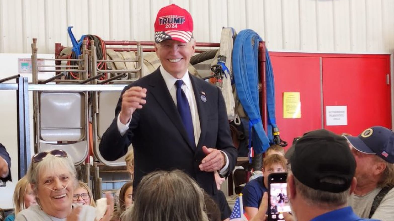 Joe Biden dons a pro-Donald Trump hat during an appearance at a Pennsylvania fire station.