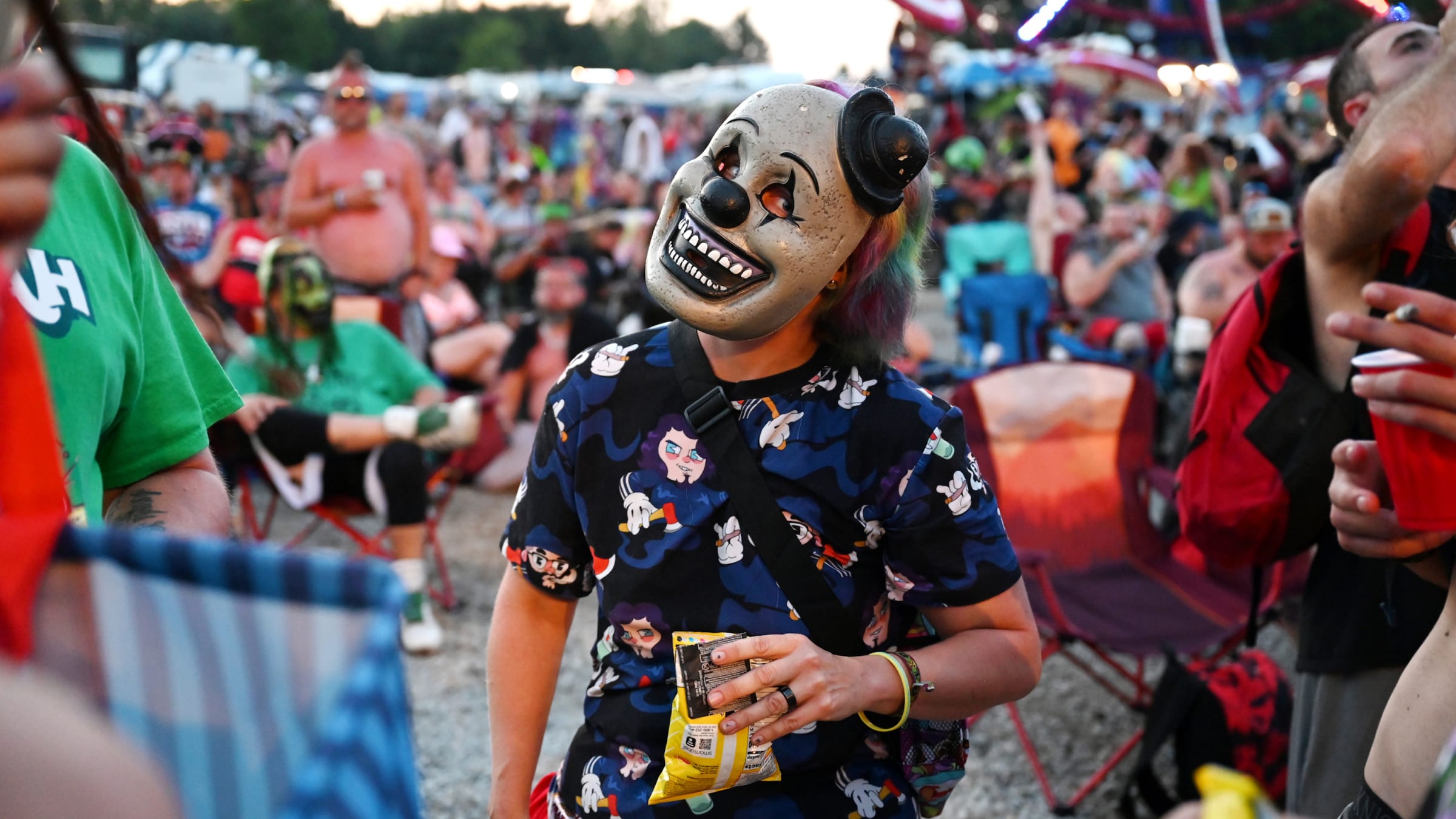 A fan in a clown mask poses at the 2023 Gathering of the Juggalos