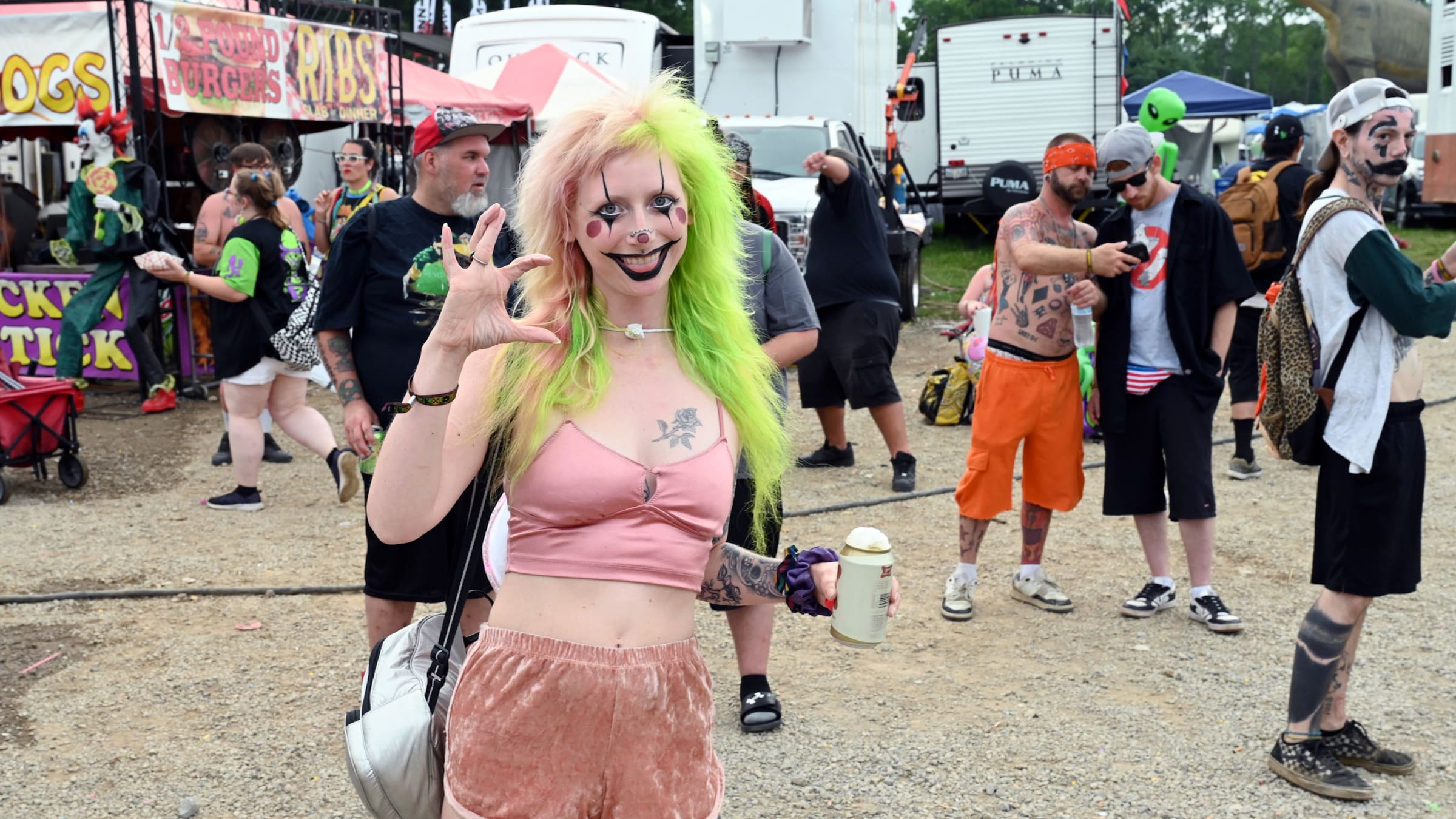 A fan in clown makeup poses at the 2023 Gathering of the Juggalos