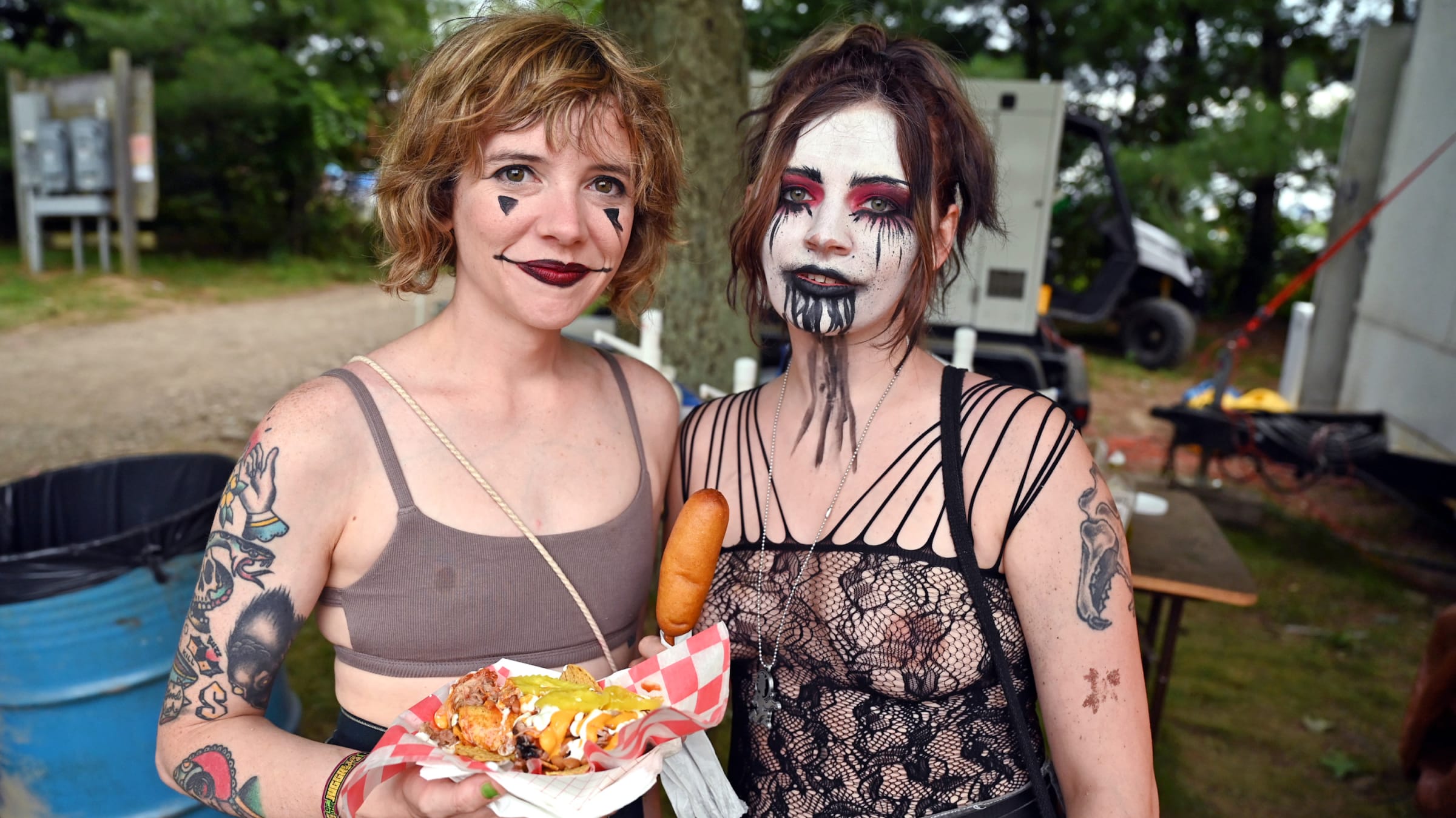 Two fans pose together at the 2023 Gathering of the Juggalos