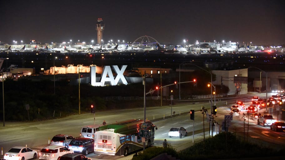 The LAX sign at night.