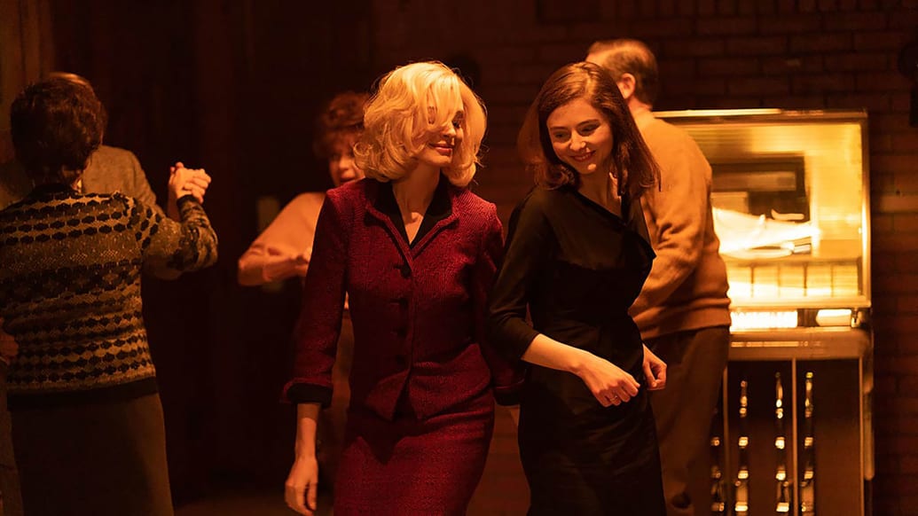 Anne Hathaway and Thomasin McKenzie dancing in a still from 'Eileen'