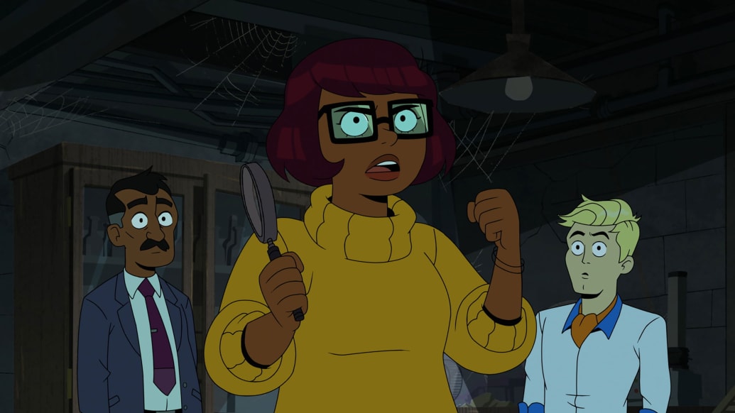 Velma holds up a magnifying glass in a still from “Velma”