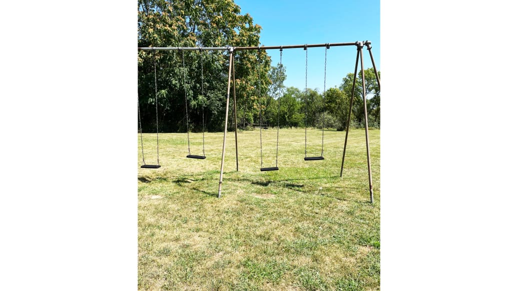 A photo that includes a Swing Set.