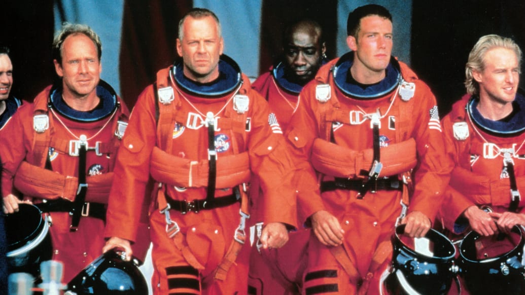 Steve Buscemi, Will Patton, Bruce Willis, Michael Clarke Duncan, Ben Affleck, and Owen Wilson walking in NASA uniforms in a scene from the film 'Armageddon', in 1998.