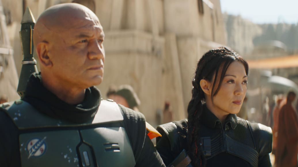A photo including (L-R): Temura Morrison is Boba Fett and Ming-Na Wen is Fennec Shand in Lucasfilm's THE BOOK OF BOBA FETT