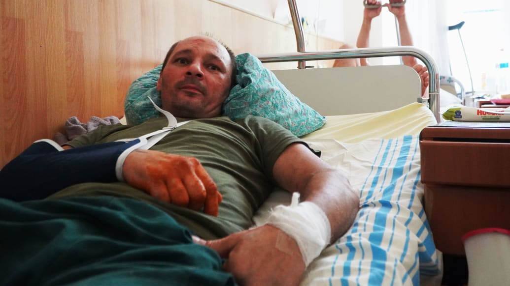 A wounded soldier on a hospital bed.