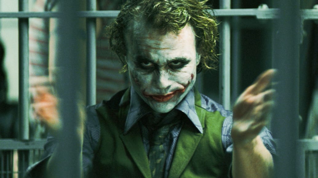 A photo including a still from the Film The Dark Knight