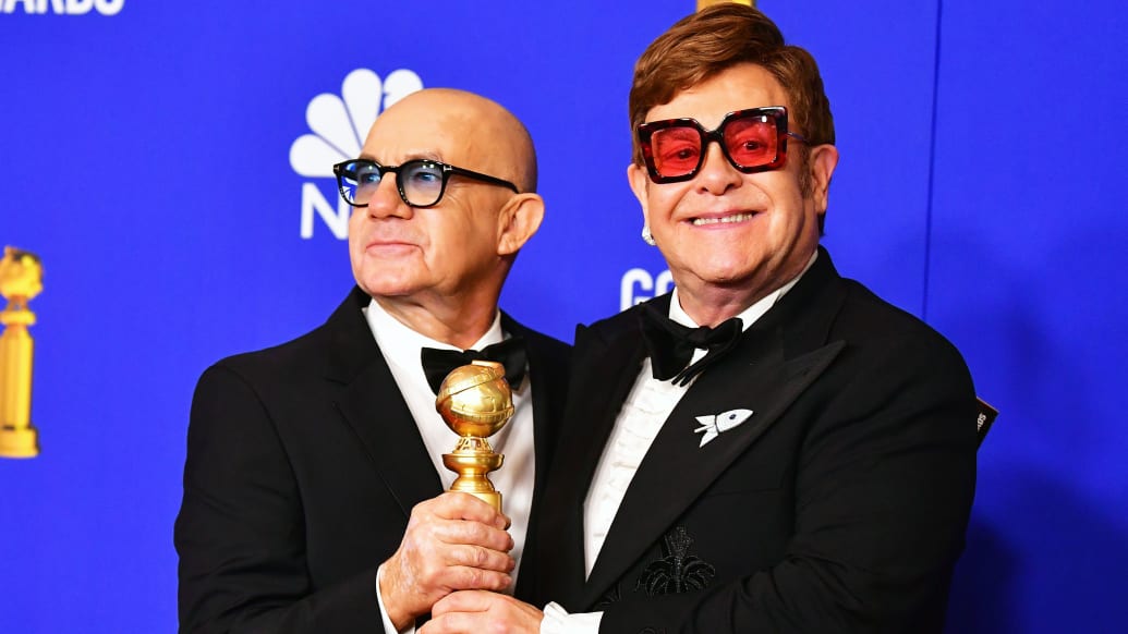 A photo including Bernie Taupin and Elton John