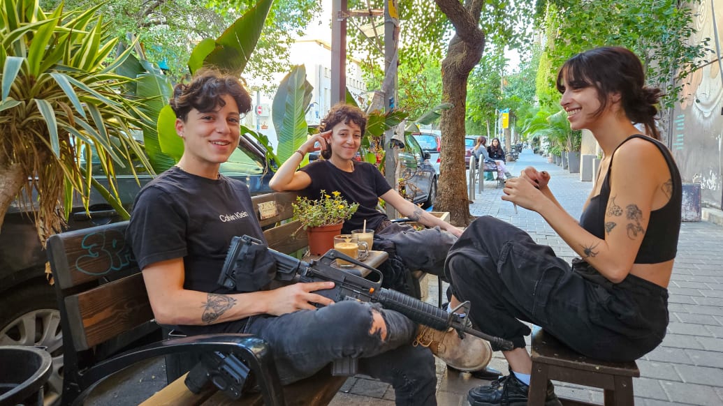 Young people in Tel Aviv carrying weapons around.