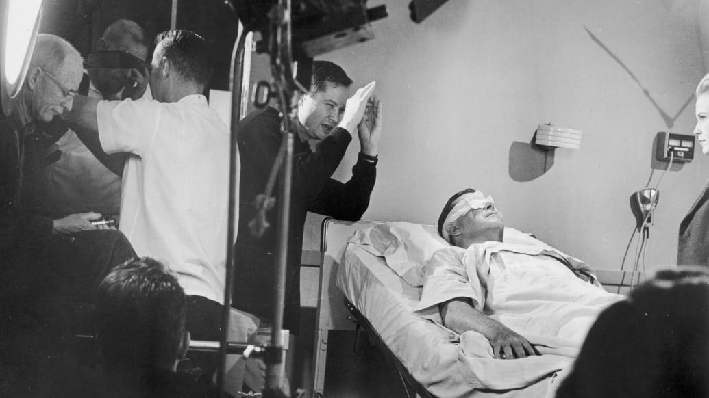 Director Roger Corman lines up a shot during the filming of X: The Man with the X-Ray Eyes.