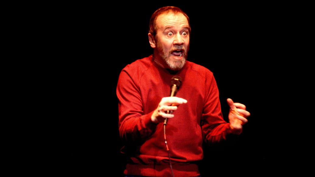A photo including George Carlin performing in Chicago, Illinois
