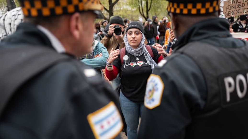 A photo including police blocking students from the School of the Art Institute of Chicago, Roosevelt College, and Columbia College