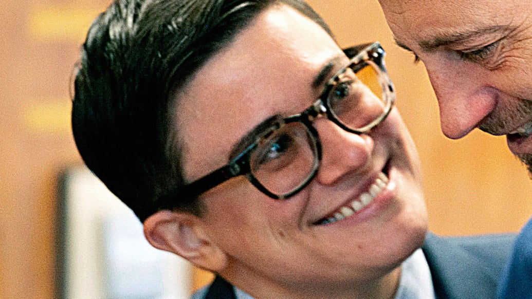 A person smiling and wearing glasses