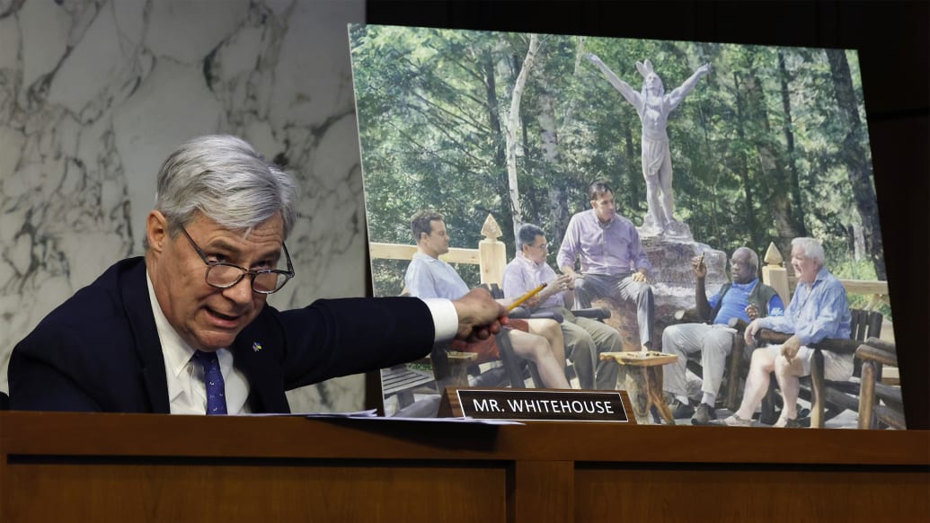 Senate Judiciary Committee member Sen. Sheldon Whitehouse (D-RI) displays a copy of a painting featuring Supreme Court Associate Justice Clarence Thomas alongside other conservative leaders during a hearing on Supreme Court ethics reform. 