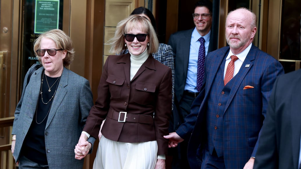 E. Jean Carroll, middle, sports a broad smile as she and her legal team depart court.