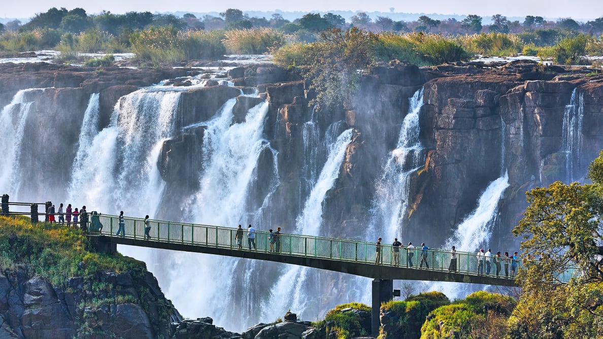 Tourists cross the Knife Edge bridge at Victoria Falls