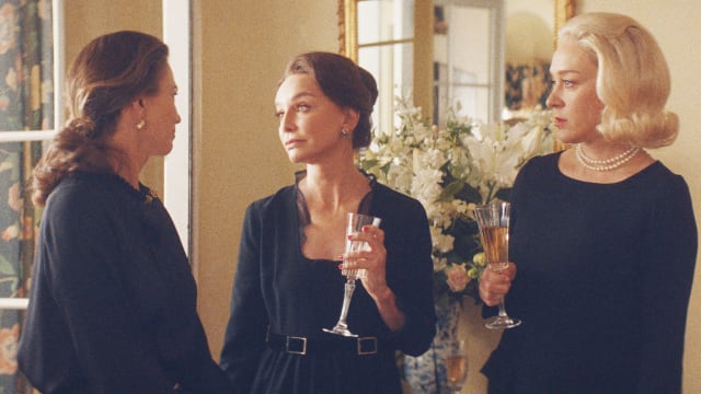 Diane Lane, Calista Flockhart and Chloe Sevigny in black talking to each other in 'Feud: Capote vs the Swans'