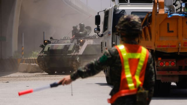 An armored vehicle passes during a drill in New Taipei City, Taiwan.