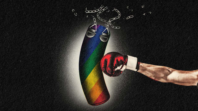 A boxing glove punches and breaks a rainbow-themed punching bag