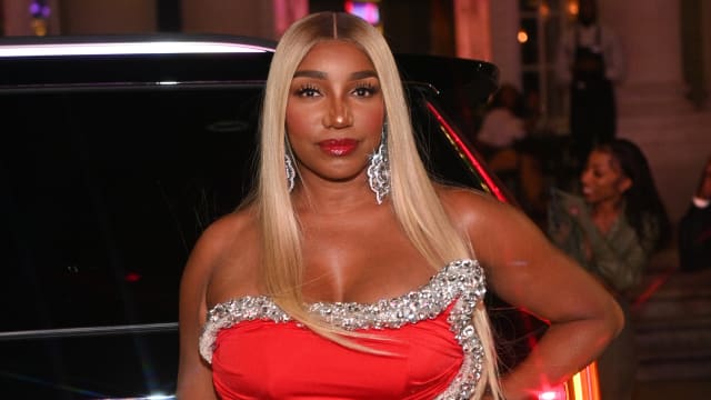 NeNe Leakes poses in a red dress at a birthday party in Georgia