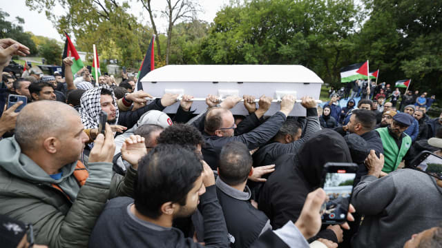 Mourners carry the coffin of six-year-old Wadea Al-Fayoume during his funeral at Parkholm Cemetery.