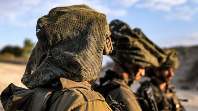 Israeli army soldiers stand at a position in the upper Galilee region of northern Israel near the border with Lebanon
