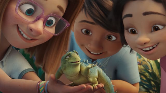 Leo the iguana is held by three kids in a still from 'Leo'
