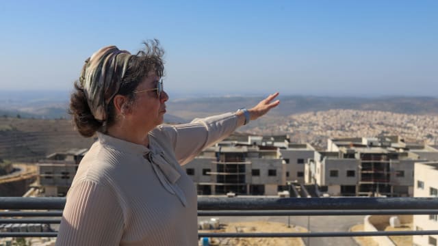 A person points out to the distance in the West Bank.