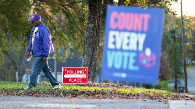 Emory Jones walks past a sign for a polling place in Winston Salem, North Carolina
