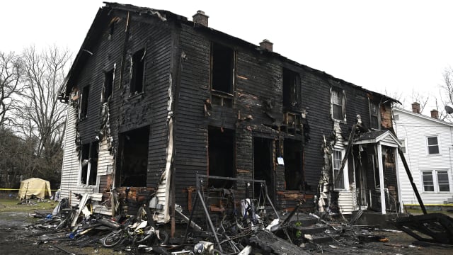 A burned two-family home in Somers, Connecticut, where four children died.