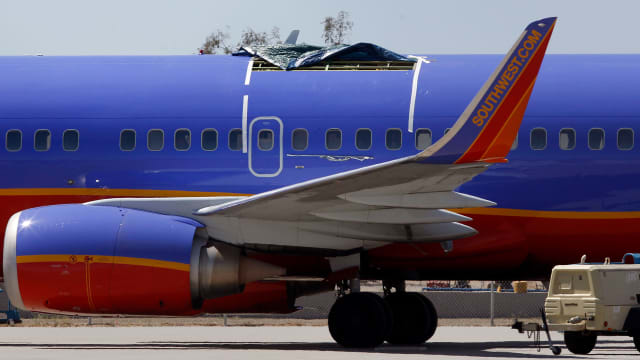 A Southwest Airlines Boeing plane sits at the Yuma International Airport in 2011, after the plane had a section of fuselage tear from the plane during a flight.
