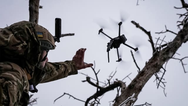 Ukrainian serviceman launches a kamikaze FPV drone at a front line.