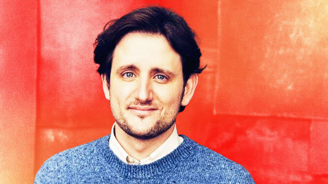 Photo illustration of Zach Woods on an orange and red background