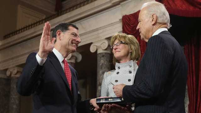 U.S. Sen. John Barrasso (R-WY) (L) participates in a reenacted swearing-in with his wife Bobbi Brown and U.S. Vice President Joe Biden