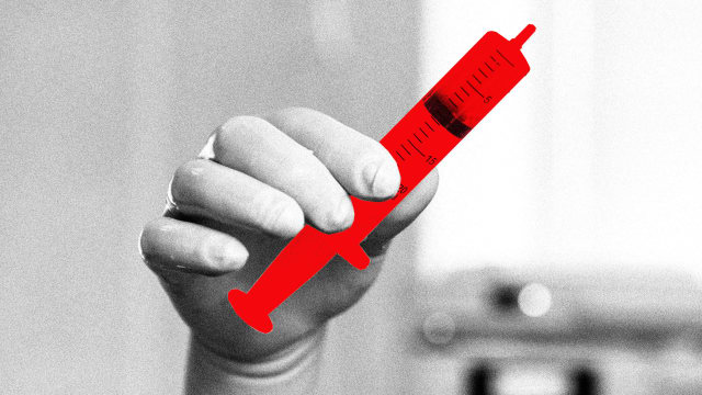 A photo illustration of a doctors hand holding a red syringe