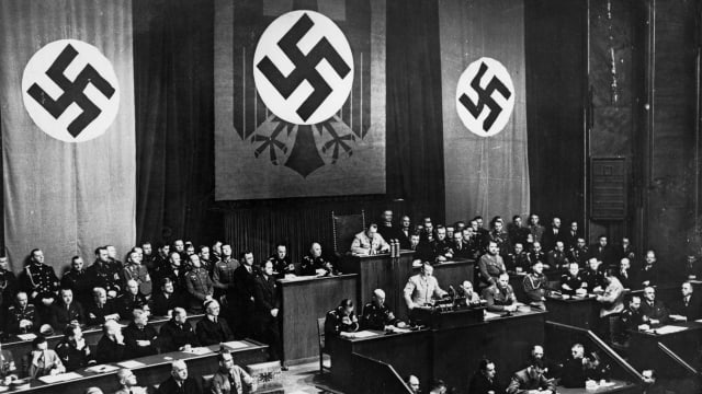 German Chancellor Adolf Hitler speaks at the Reichstag in Berlin in 1936. Also pictured are Rudolf Hess and Joseph Goebbels.