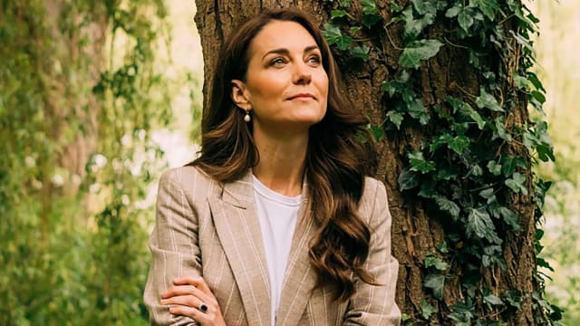 Kate Middleton leans against a tree trunk for portrait.