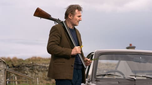 Liam Neeson holds a gun in a still from 'In the Land of Saints and Sinners'