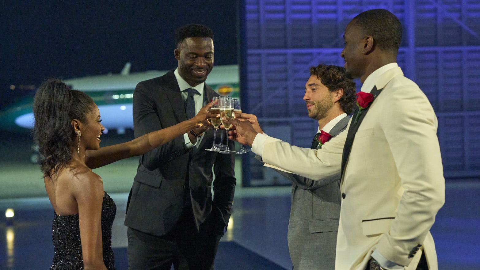 Photo still of Charity Lawson, Dotun, Joey, and Xavier toasting champagne in 'The Bachelorette'