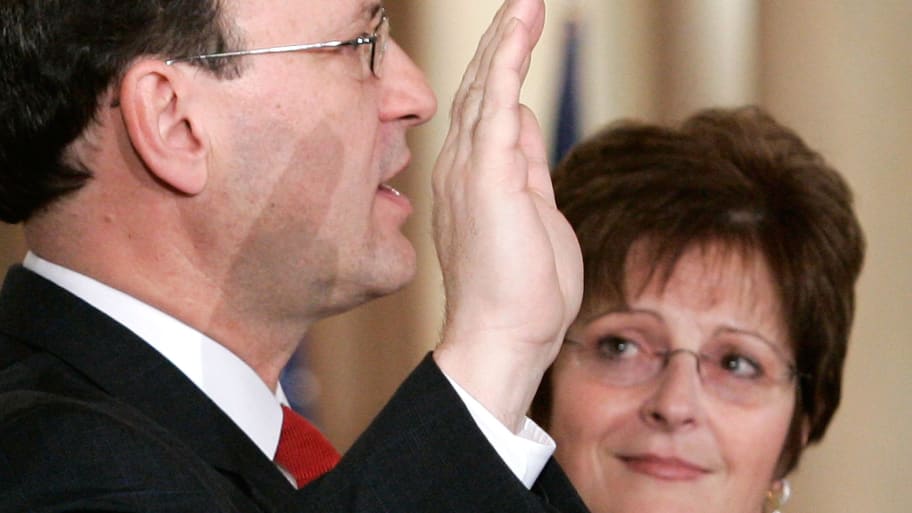 U.S. Supreme Court Justice Samuel Alito (L) is sworn in as his wife Martha-Ann looks on.