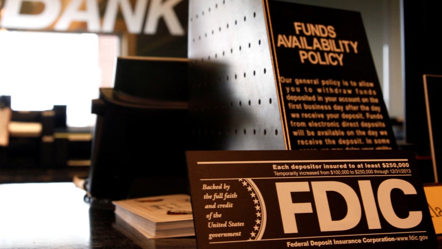 Signs explaining Federal Deposit Insurance Corporation (FDIC) and other banking policies are shown on the counter of a bank in Westminster, Colorado November 3, 2009.