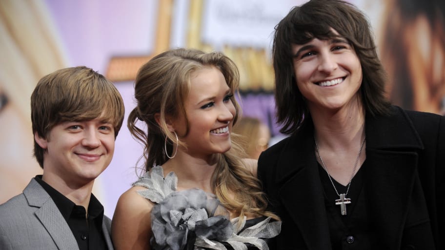Cast members Jason Earles (L), Emily Osment (C) and Mitchell Musso (R) attend the premiere of "Hannah Montana the Movie" in Los Angeles April 2, 2009.